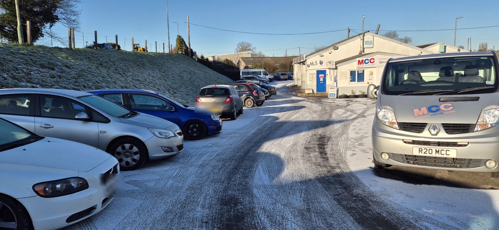 A frosty morning on the forecourt, with the MCC liveried van in front of the workshop