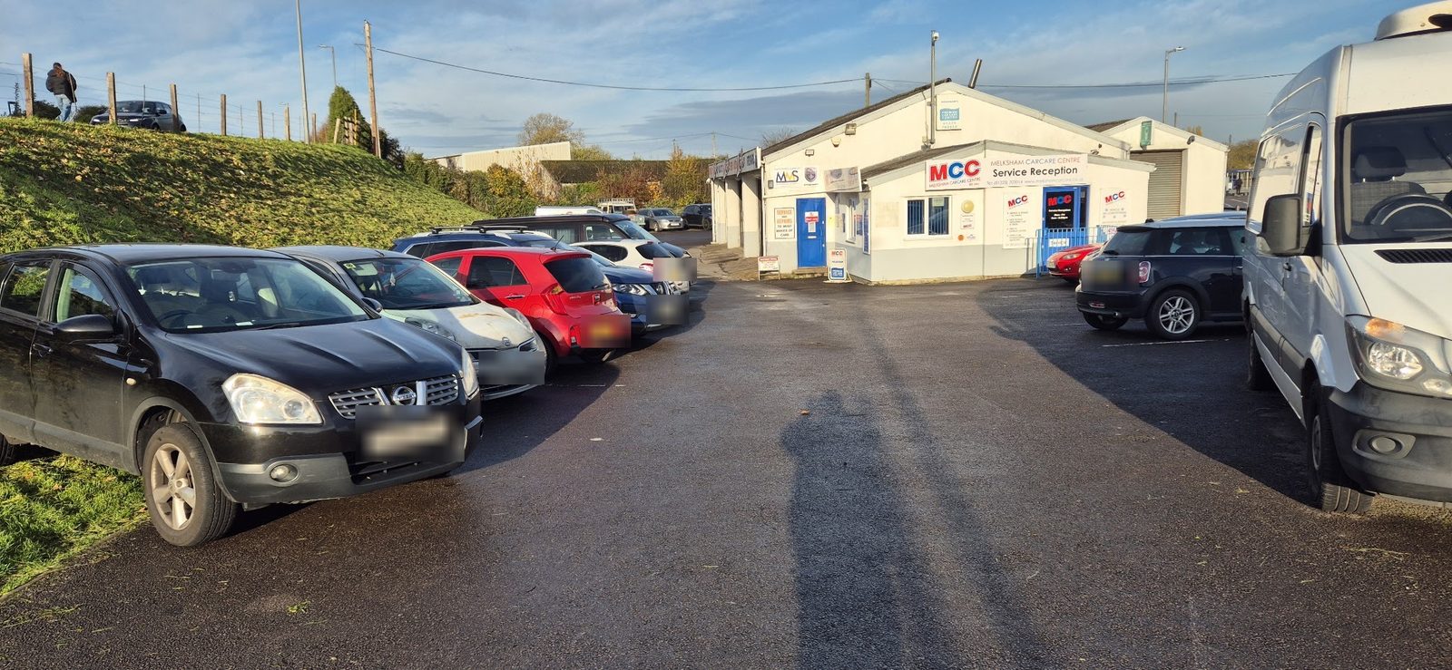 The forecourt in the sun with the Service Reception building behind