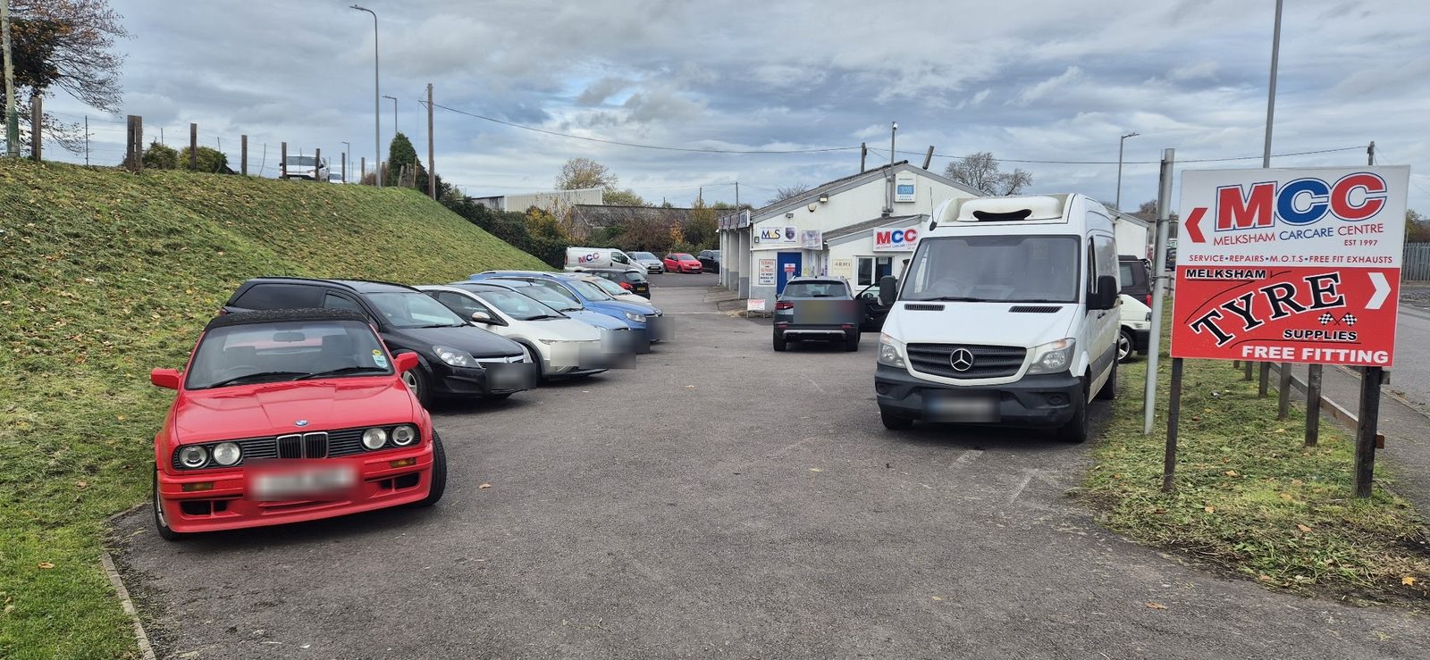 The forecourt and the roadside MCC Melksham Carcare Centre sign, Est 1997